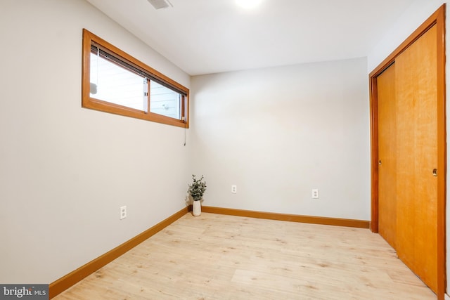 unfurnished room with light hardwood / wood-style floors