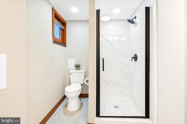 bathroom featuring toilet and a shower with shower door