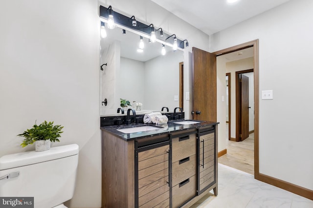 bathroom featuring toilet and vanity