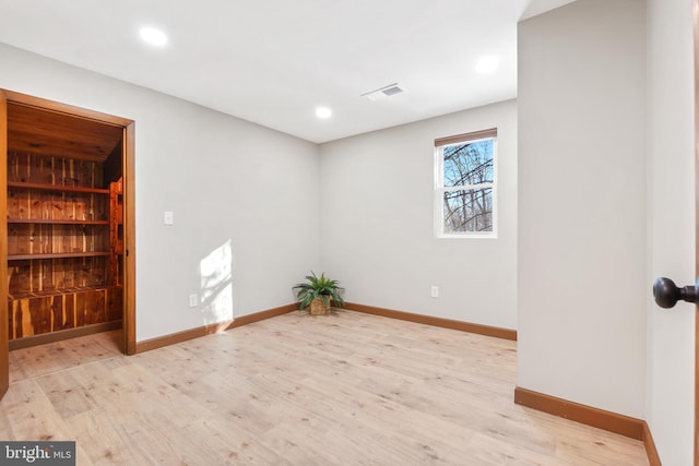 spare room with light hardwood / wood-style floors