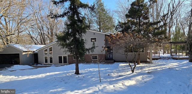 snow covered property featuring a garage