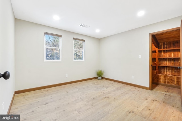 unfurnished room with light hardwood / wood-style flooring