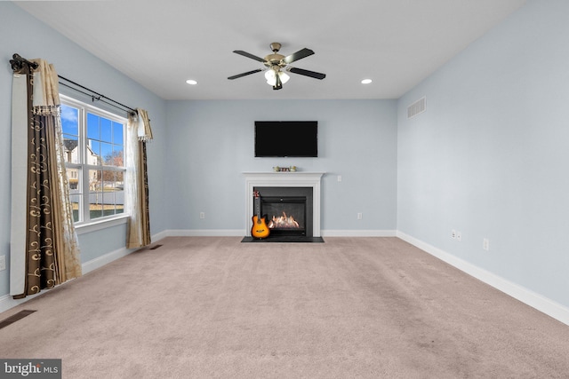 unfurnished living room featuring carpet flooring and ceiling fan