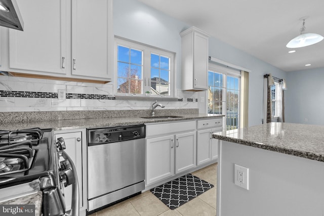 kitchen with dishwasher, white cabinetry, sink, and light stone countertops