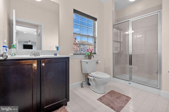 bathroom with vanity, a shower with door, tile patterned floors, and toilet