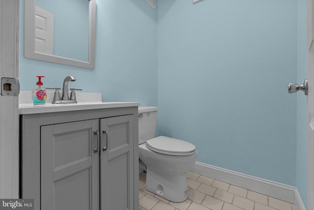 bathroom with tile patterned floors, vanity, and toilet