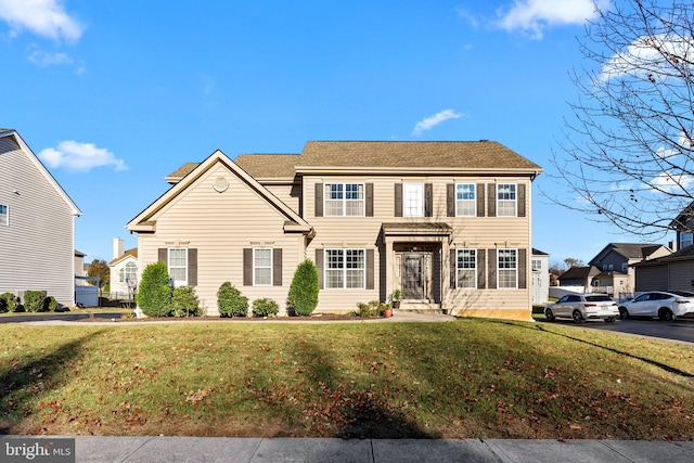 colonial-style house with a front lawn