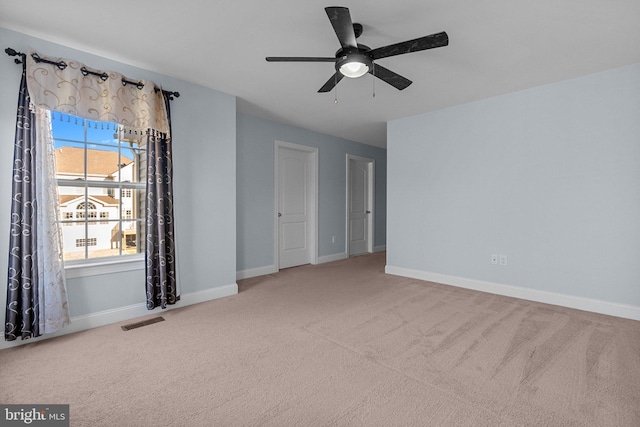 carpeted spare room with ceiling fan