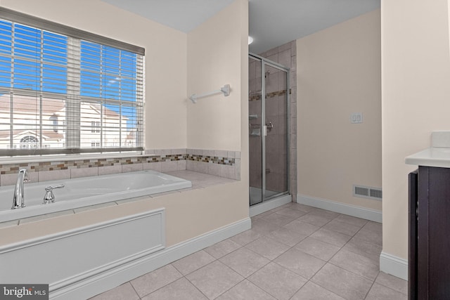 bathroom with tile patterned flooring, vanity, and a shower with shower door