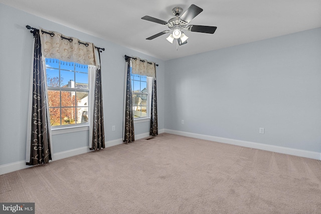 carpeted spare room with ceiling fan