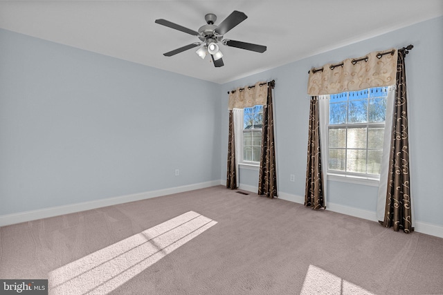 unfurnished room with carpet flooring and ceiling fan