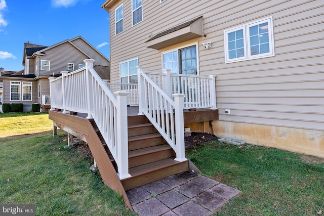 entrance to property with a deck and a yard