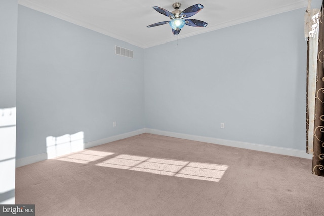 carpeted empty room featuring ceiling fan and ornamental molding