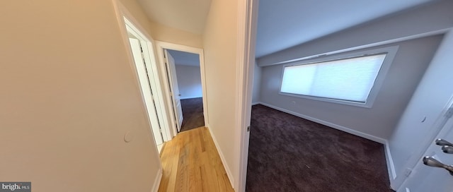 hallway with light hardwood / wood-style floors