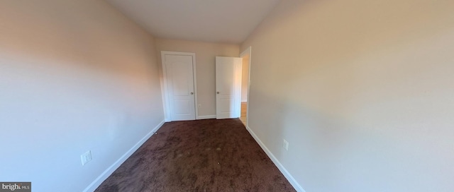 corridor with dark colored carpet