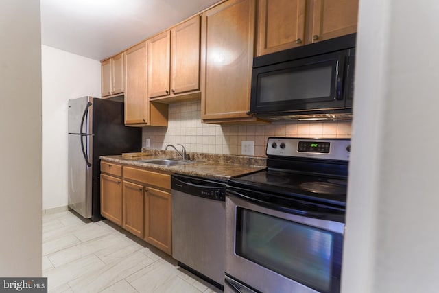 kitchen featuring backsplash, sink, and stainless steel appliances