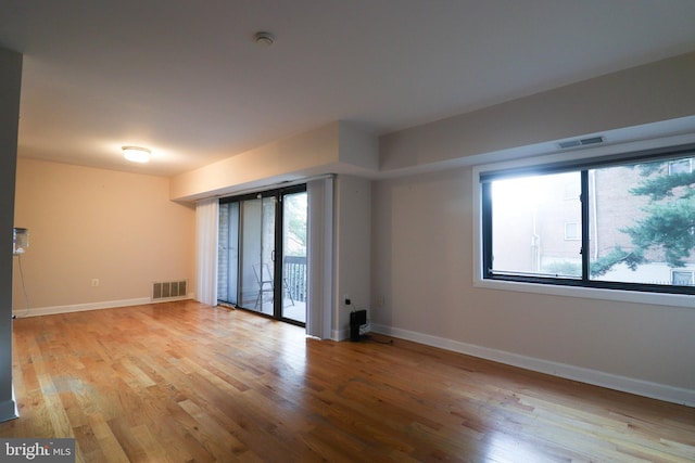 spare room featuring light hardwood / wood-style flooring