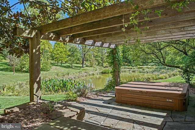 view of patio / terrace with a water view and a pergola