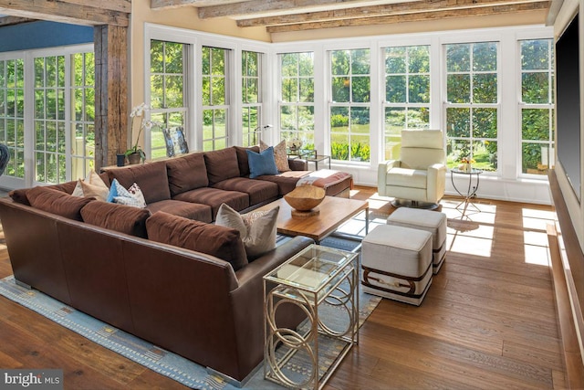 sunroom / solarium featuring beam ceiling