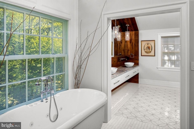 bathroom with vanity, tile patterned floors, and a tub