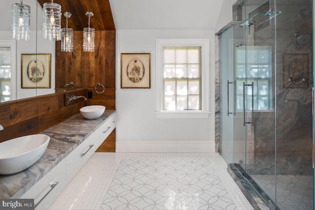 bathroom featuring a shower with door, tile patterned flooring, lofted ceiling, and vanity