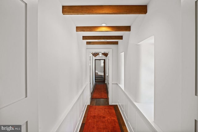 hall featuring wood-type flooring and beam ceiling