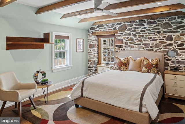 bedroom with ceiling fan, beamed ceiling, and light hardwood / wood-style flooring