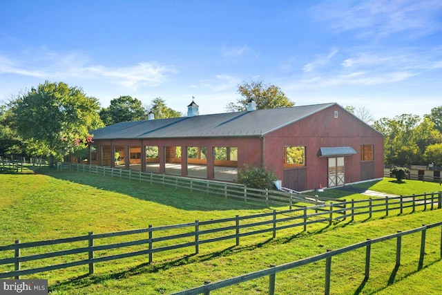 view of horse barn featuring a rural view