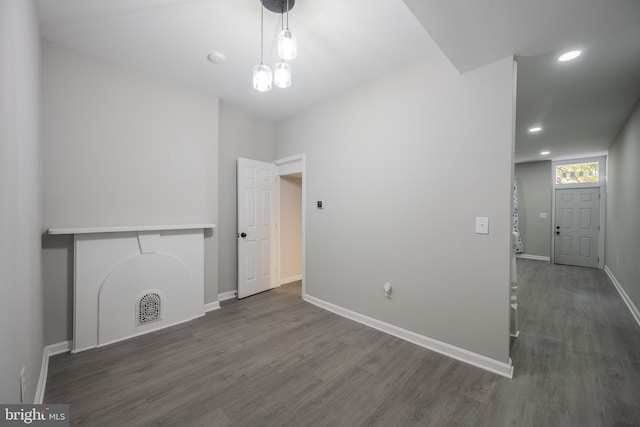 unfurnished living room with dark hardwood / wood-style floors