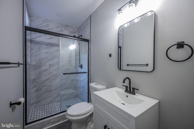 bathroom with walk in shower, vanity, and toilet