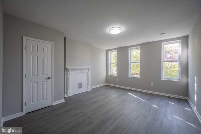 1823 N Caroline St, Baltimore, MD 21213 - unfurnished living room featuring dark wood finished floors and baseboards