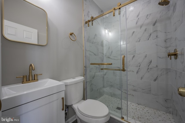 bathroom with vanity, toilet, and a shower with shower door