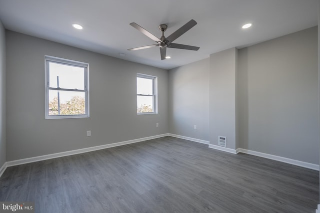 spare room with ceiling fan and dark wood-type flooring