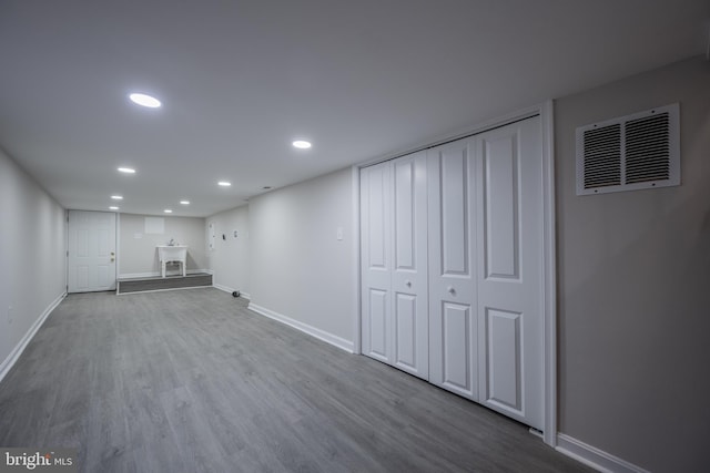 basement with light hardwood / wood-style floors