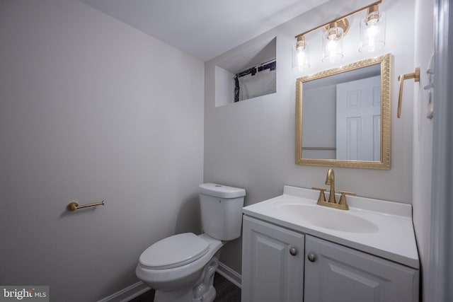 1823 N Caroline St, Baltimore, MD 21213 - bathroom with toilet, vanity, and baseboards