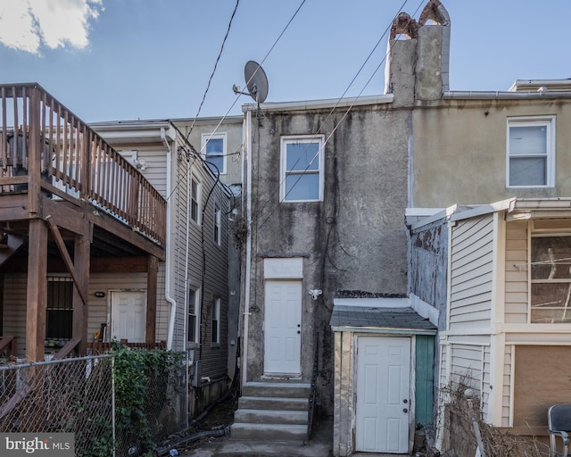 rear view of house featuring a deck