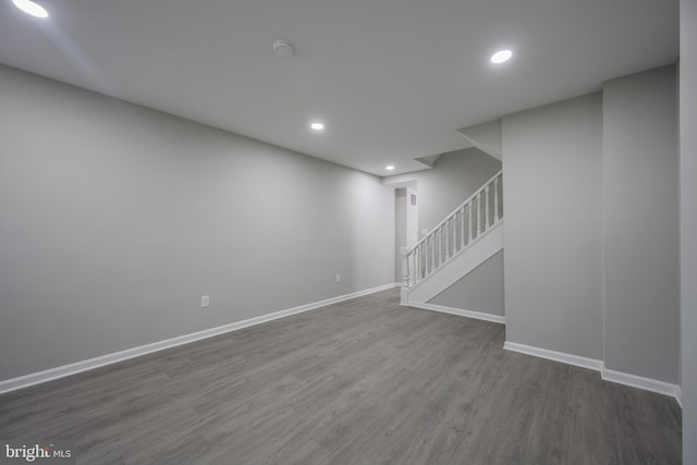 basement with dark hardwood / wood-style floors