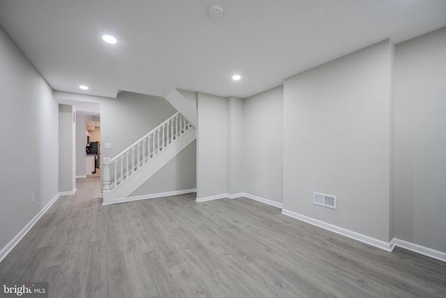 basement with hardwood / wood-style floors