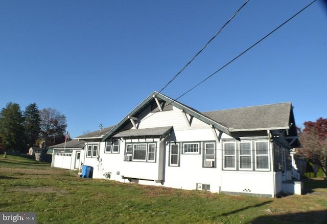 rear view of property featuring a yard