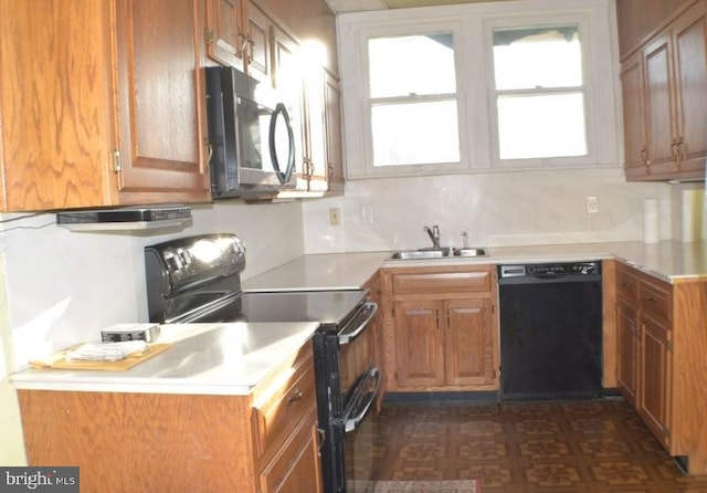 kitchen featuring black appliances, sink, and tasteful backsplash