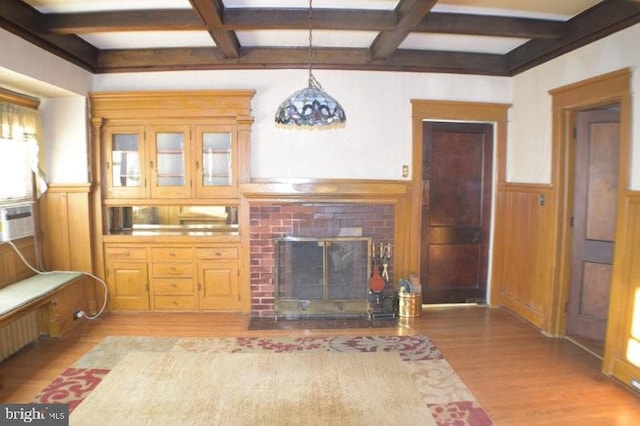 living room with hardwood / wood-style floors, a fireplace, beam ceiling, and coffered ceiling