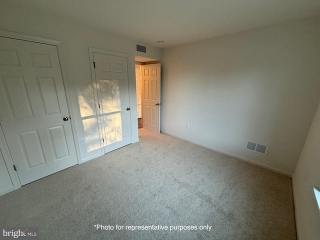 unfurnished bedroom with light colored carpet