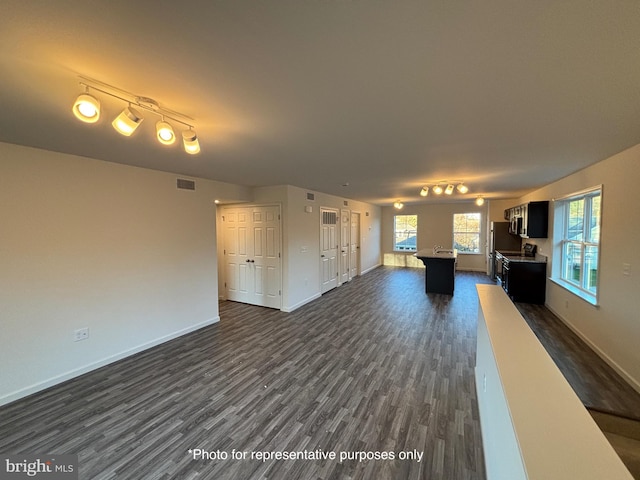 unfurnished living room featuring dark hardwood / wood-style floors, track lighting, and billiards