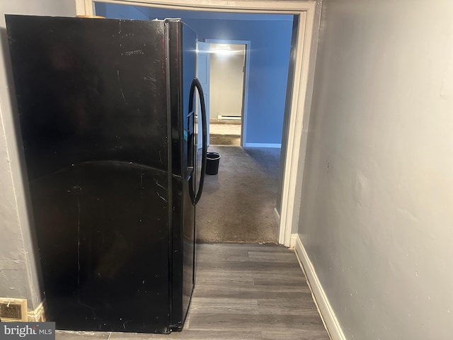 corridor featuring hardwood / wood-style floors and a baseboard heating unit