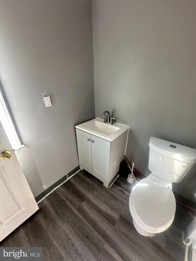 bathroom featuring hardwood / wood-style floors, vanity, and toilet