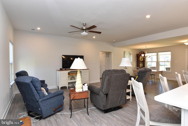 living room featuring hardwood / wood-style flooring and ceiling fan