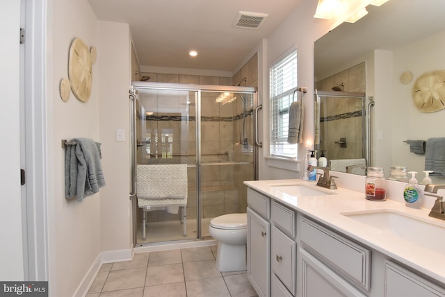 bathroom featuring vanity, an enclosed shower, and tile patterned flooring