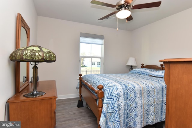 bedroom with ceiling fan and dark hardwood / wood-style flooring