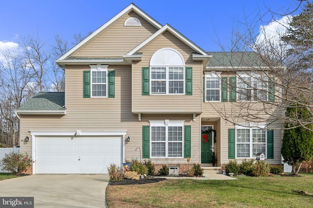 view of front of property featuring a garage and a front lawn