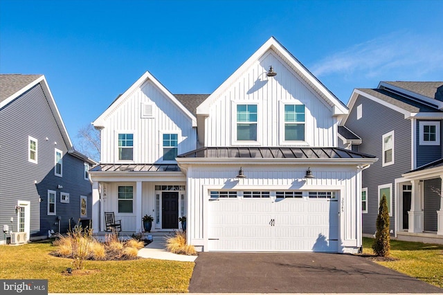 modern inspired farmhouse featuring an attached garage, a standing seam roof, aphalt driveway, and board and batten siding